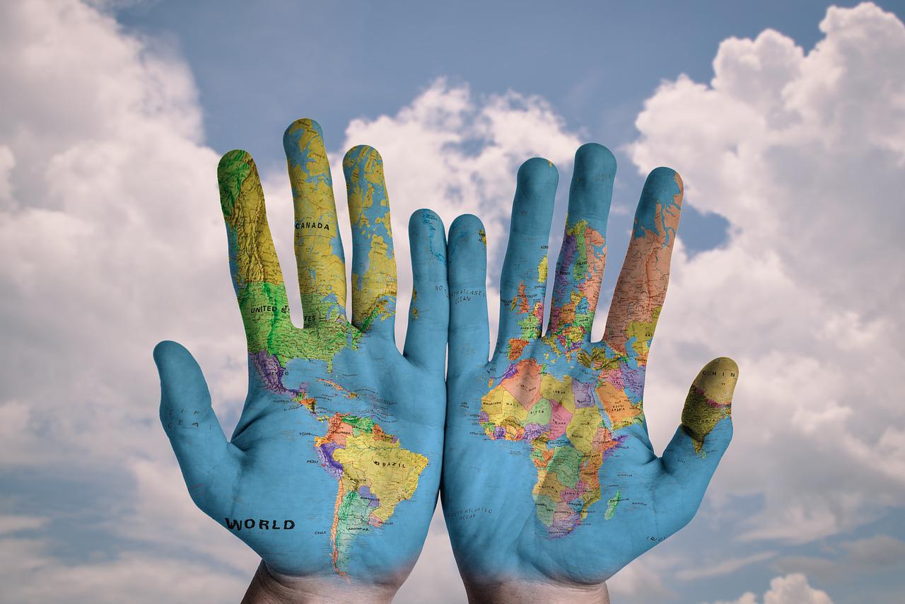 hands with a world map on