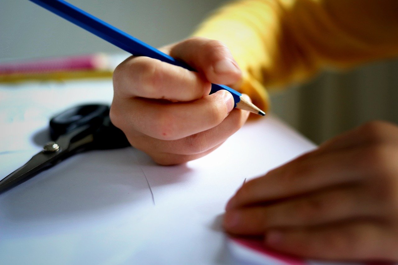 child holding pencil